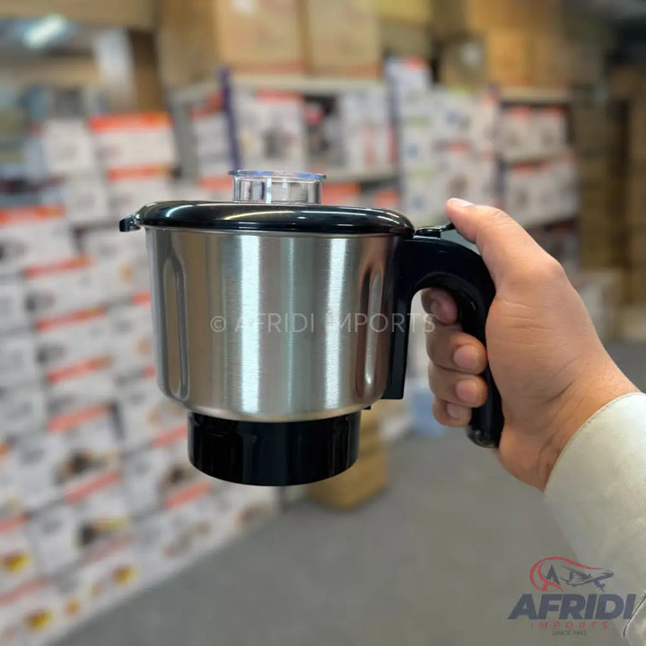 A stainless steel mixer grinder jar with a black handle and lid.