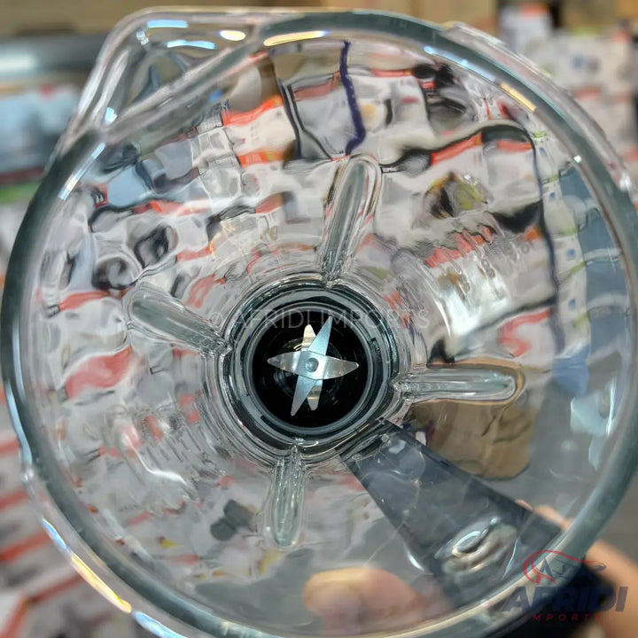 A clear glass blender jar with an integrated four-blade assembly.