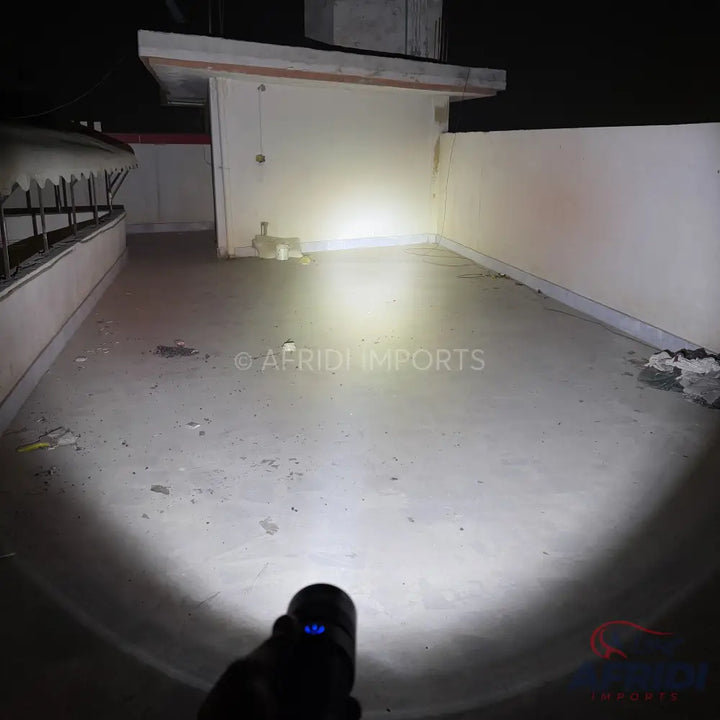 Bright, handheld flashlight illuminating a dark area.