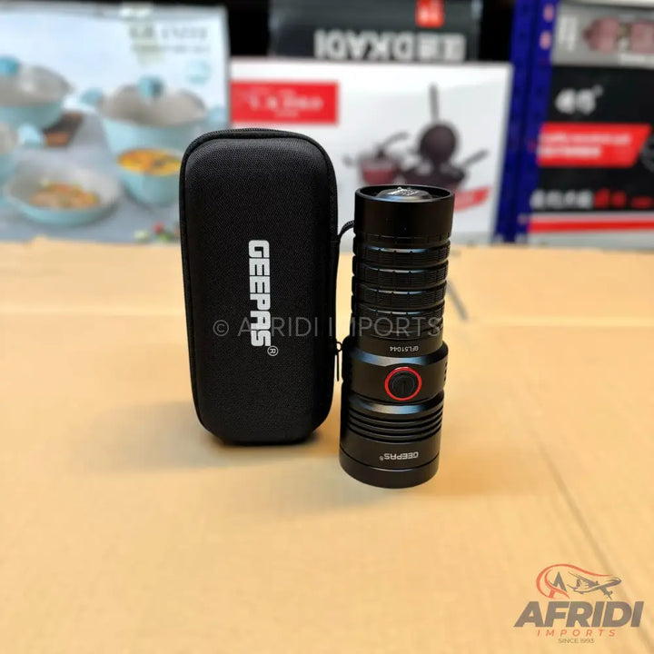 Black, cylindrical flashlight with a red power button, accompanied by a matching black carrying case.