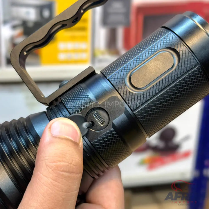 A black tactical flashlight with a USB-C charging port.