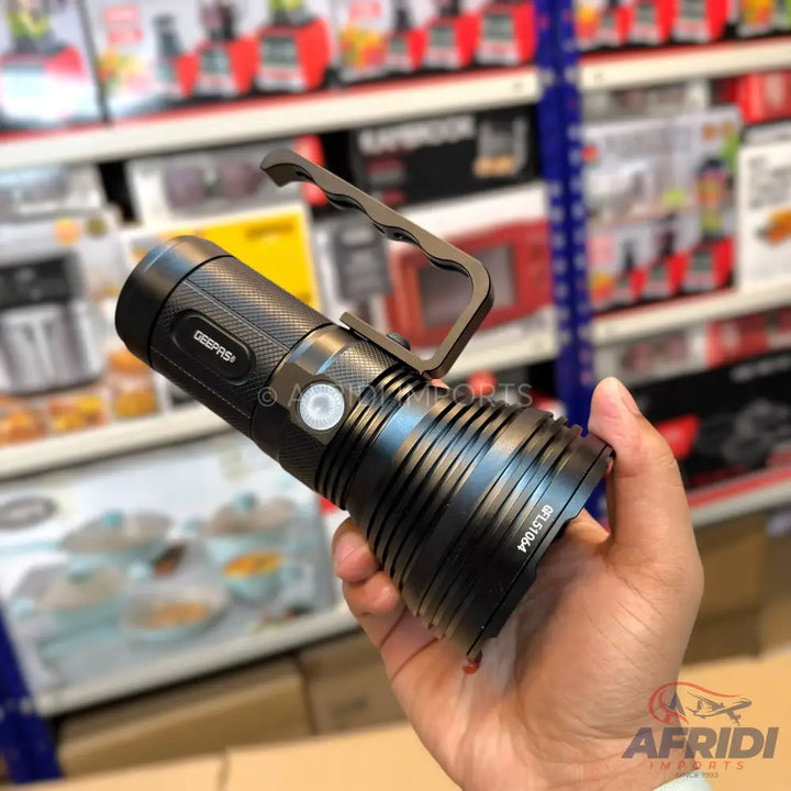 Black tactical flashlight with a side handle and ribbed body.