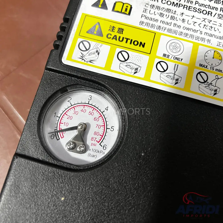 Portable air compressor with an analog pressure gauge.