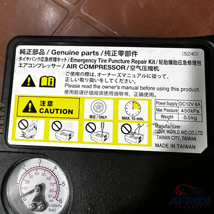 Portable air compressor and tire repair kit with a pressure gauge.
