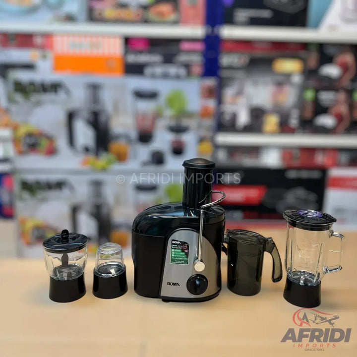 A black and silver juicer with multiple attachments including a blender, a smaller grinder, and a juice collection jug.