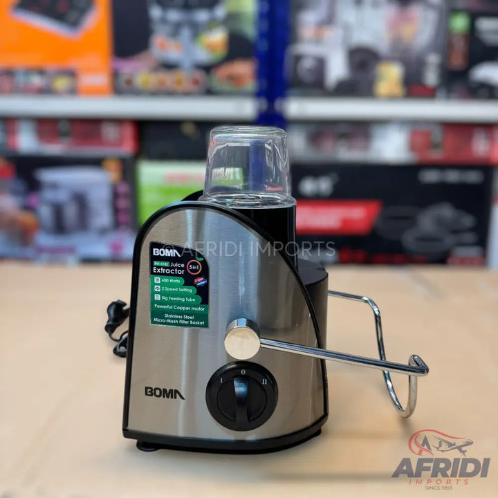 A silver and black electric juice extractor with a clear plastic top, featuring a knob control and a metal locking arm.