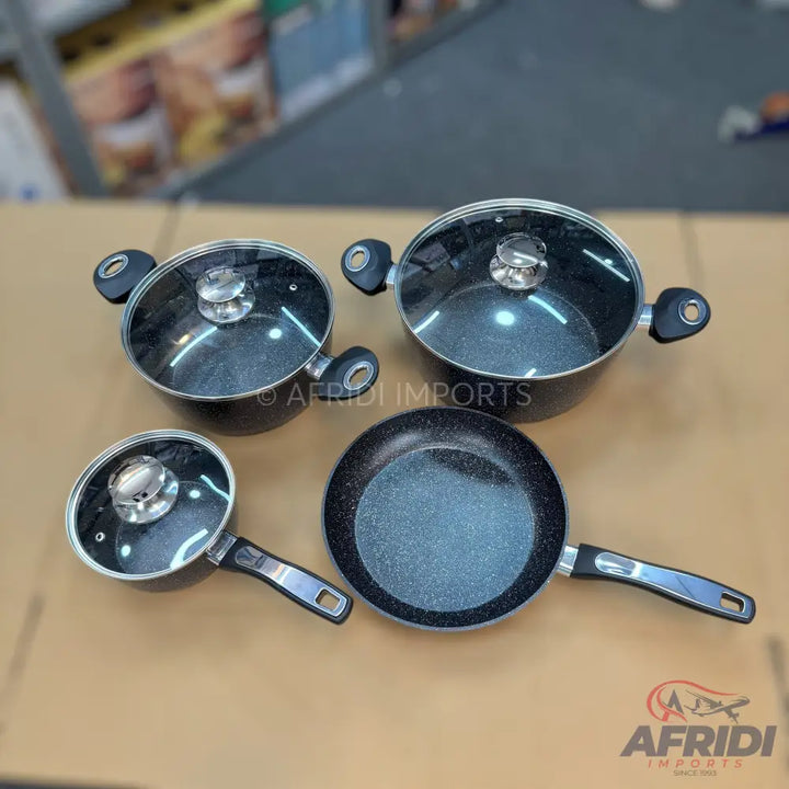 A set of black speckled non-stick cookware with glass lids and black handles.