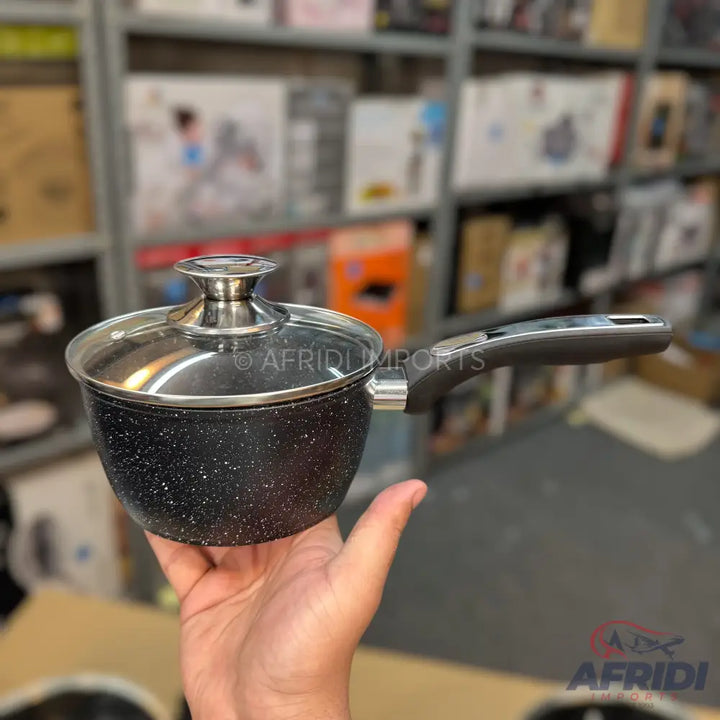 Black speckled non-stick saucepan with a glass lid and ergonomic handle.