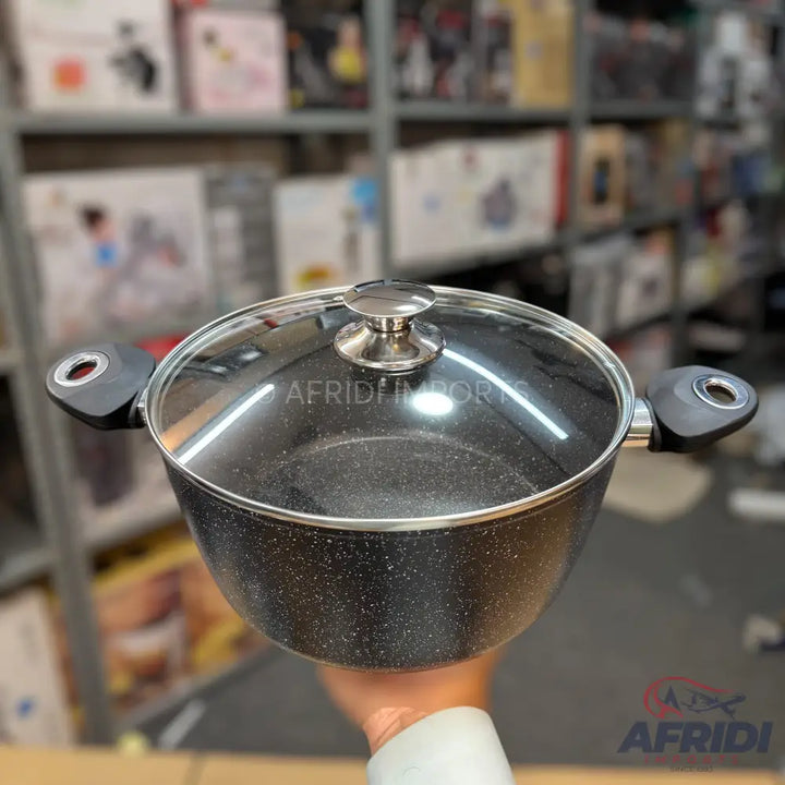 Black speckled non-stick cooking pot with a glass lid and black handles.