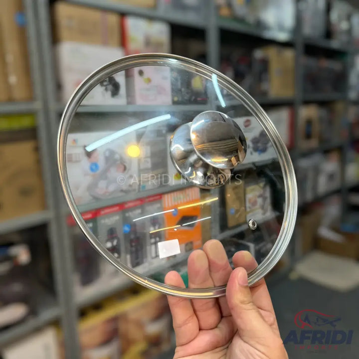 Clear glass pot lid with a metal rim and a polished metal knob.