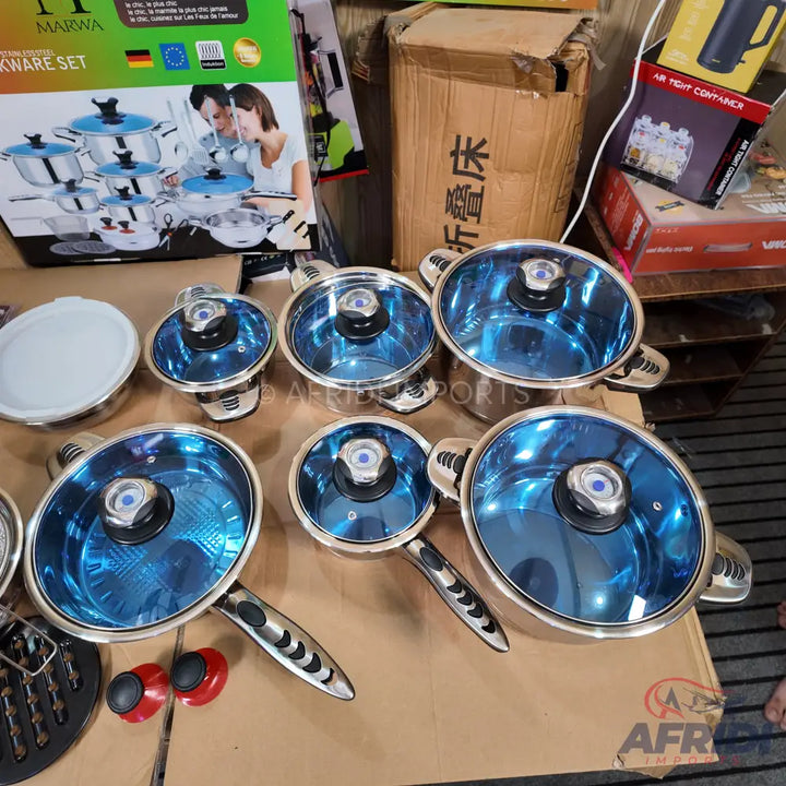 Stainless steel cookware set with blue glass lids.