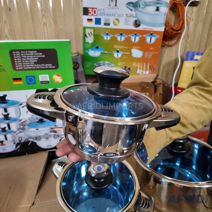 Stainless steel pot with a blue glass lid and black knob handle.