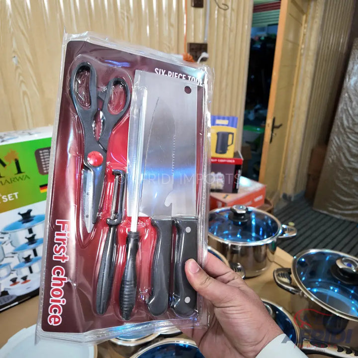 A six-piece kitchen tool set including scissors, a peeler, a sharpening steel, and three knives, packaged in clear plastic.