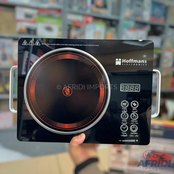 Black electric induction cooktop with touch controls and a digital display.