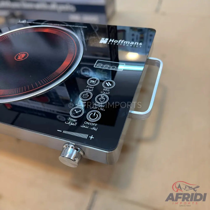 Black single-burner induction cooktop with touch controls and a rotary knob.