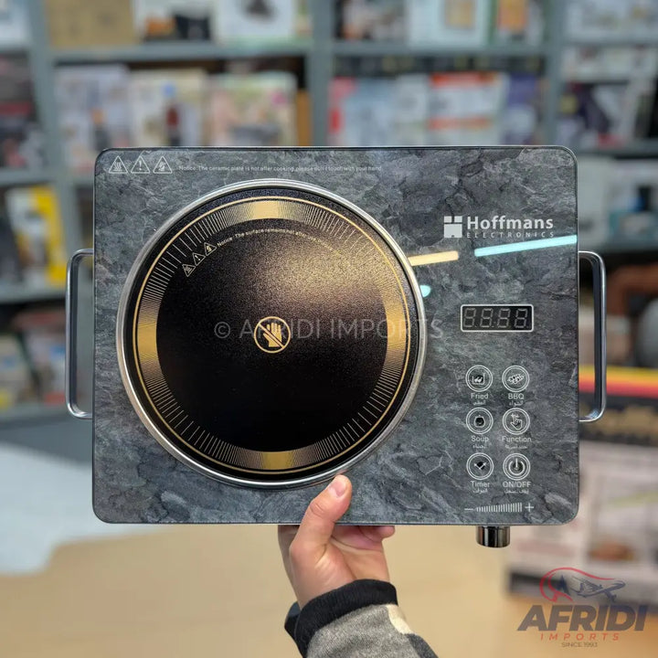 A portable induction cooktop with a gray marble-like finish, a single cooking zone, and digital controls for various cooking functions.