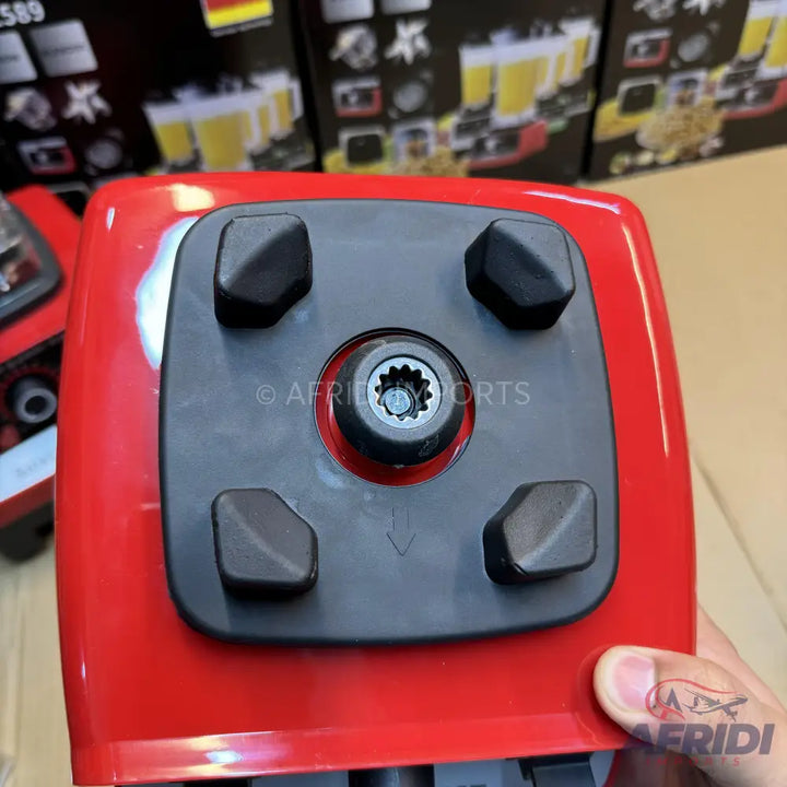 Red blender base with a black mounting plate and four rubber feet.