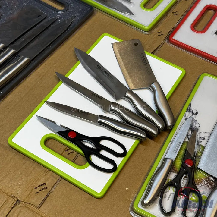 A set of kitchen knives and shears on a cutting board.