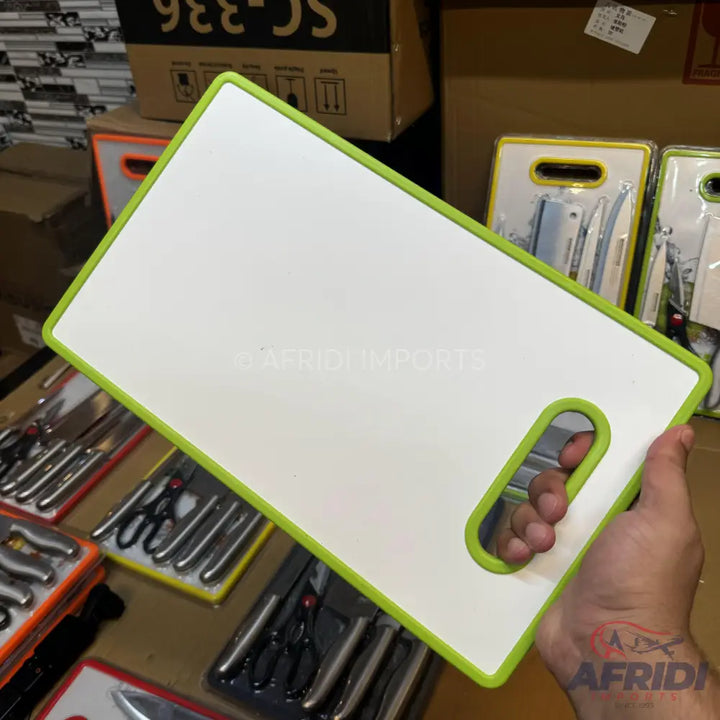White cutting board with a green trim and handle.