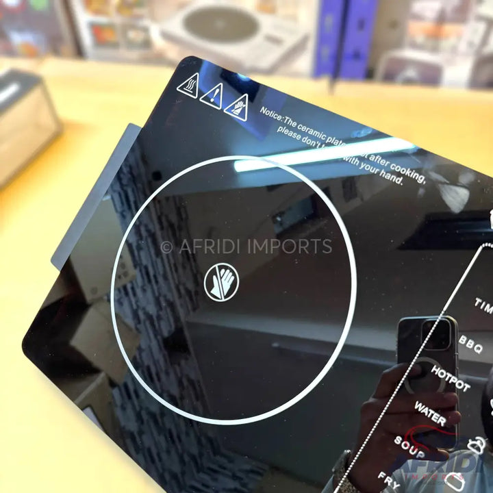 Black ceramic cooktop with touch controls and multiple cooking functions.