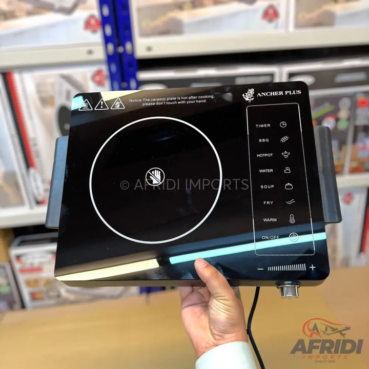 Black induction cooktop with touch controls and pre-set cooking functions.