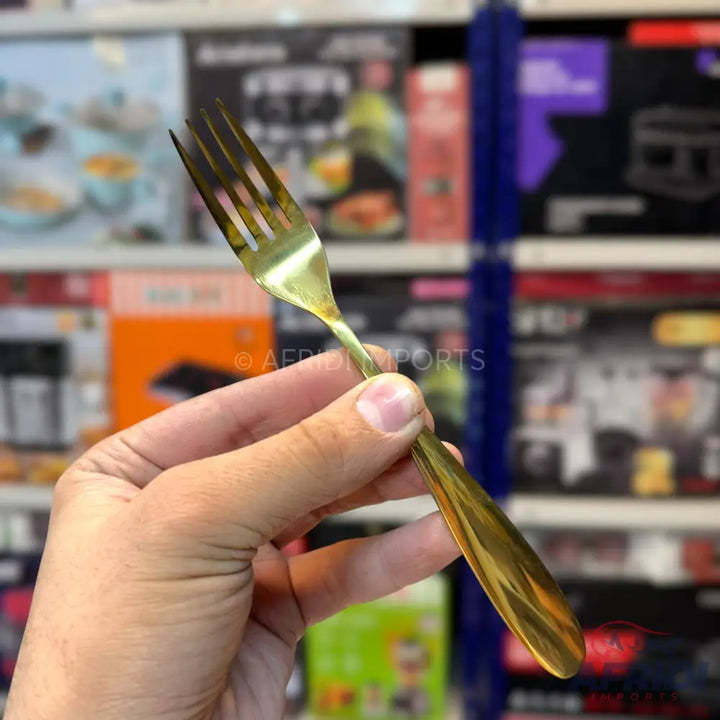 A shiny gold-colored metal fork.