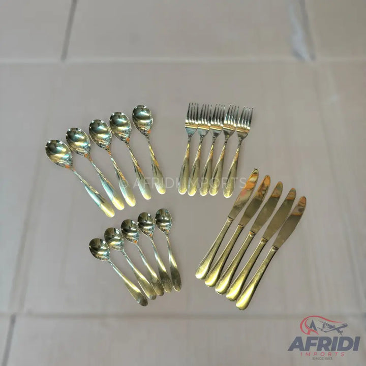 A set of shiny silver-colored spoons, forks, and knives with twisted handles.