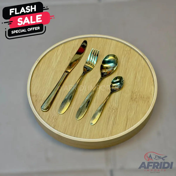 A set of four golden stainless steel utensils, including a knife, fork, and two spoons.