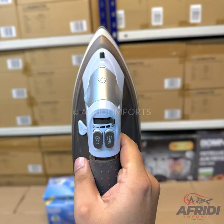 Silver and black steam iron with spray and steam buttons.