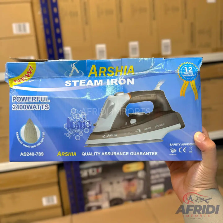 A ’NEW!’ Arshia Steam Iron with 2400 watts of power and a ceramic coating soleplate, offering a 12-month warranty and quality assurance.