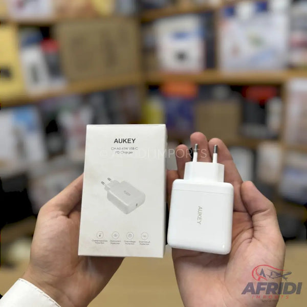 White AUKEY wall charger with two prongs, accompanied by its product box.