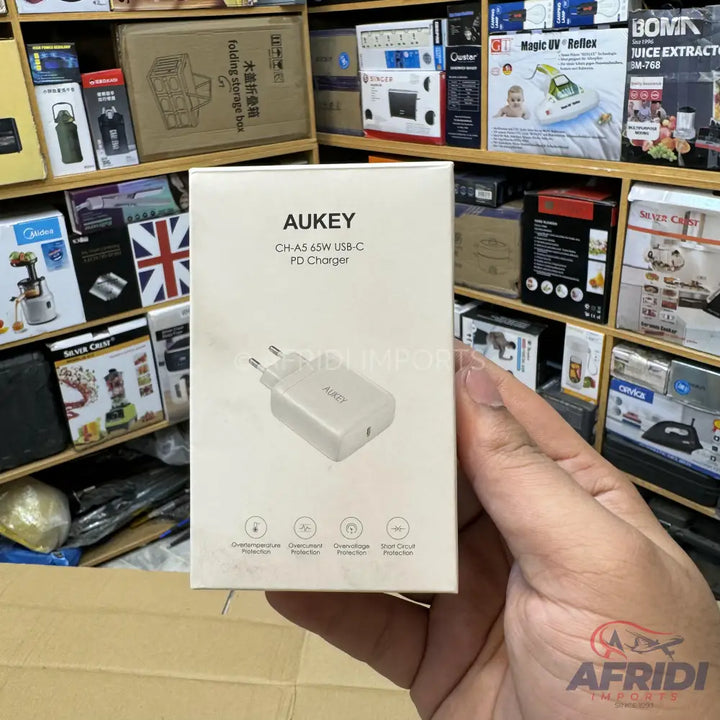White AUKEY 65W USB-C PD charger in its retail box.