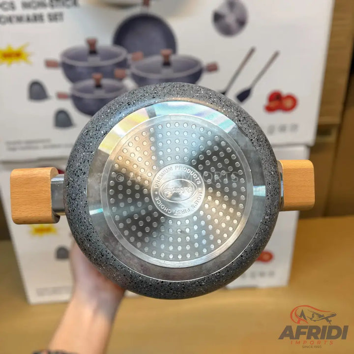 A granite-finish cooking pot with a wooden handle.