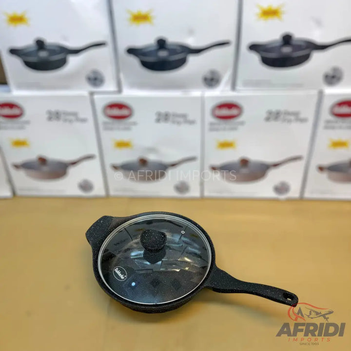 Black speckled non-stick frying pan with a glass lid.
