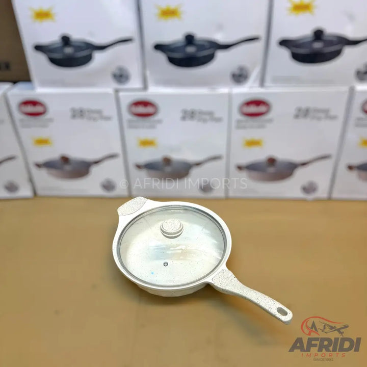 White non-stick frying pan with a glass lid.