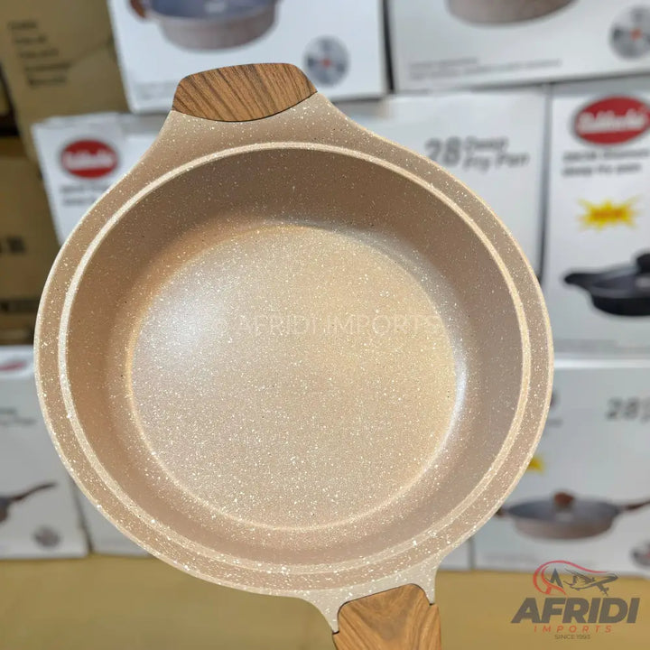 Beige speckled non-stick saucepan with wooden-look handles.