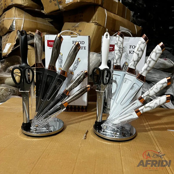 Two knife sets with rotating stands, one with dark handles and the other with white marble-patterned handles.