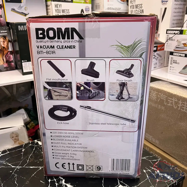 Boxed vacuum cleaner with attachments and product specifications.
