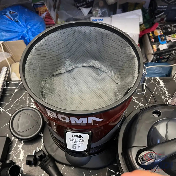 Red and black cylindrical vacuum cleaner with a grey fabric filter.