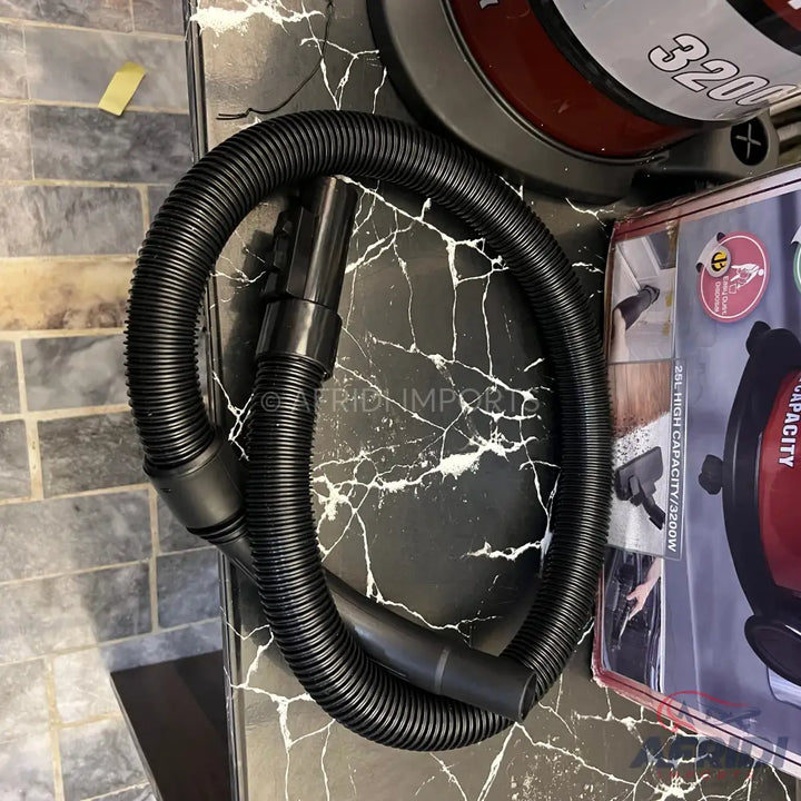 Black ribbed vacuum cleaner hose with attachments