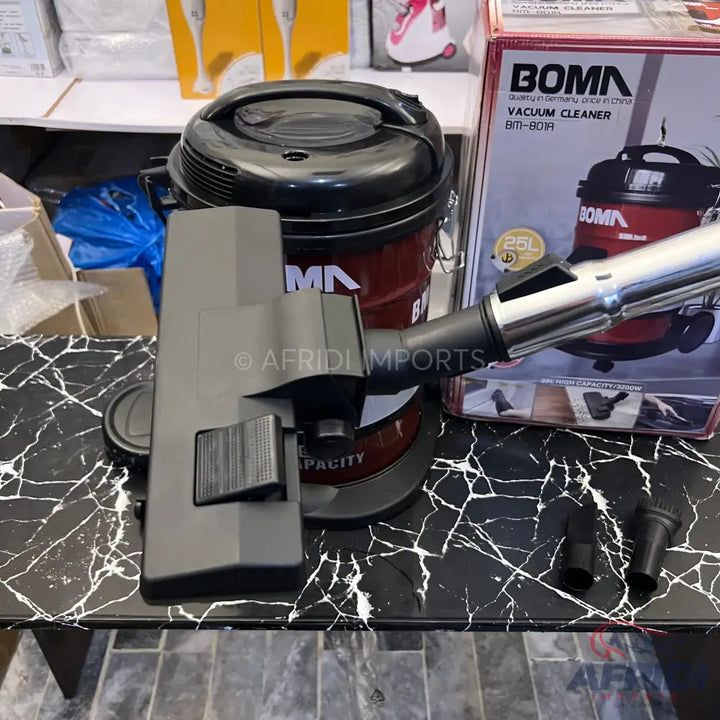 Red and black canister vacuum cleaner with attachments.