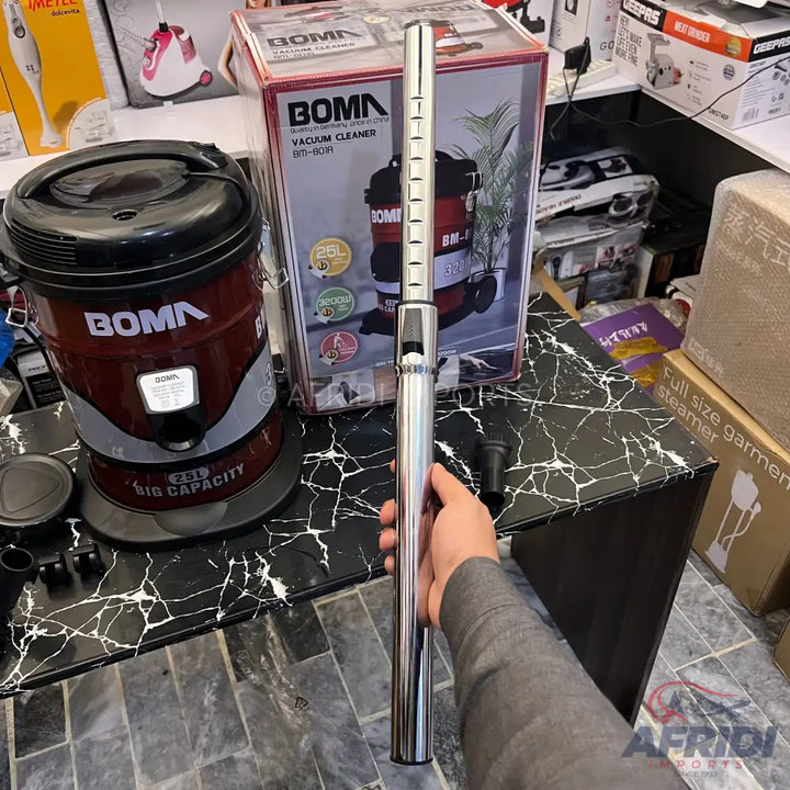A red and black BOMA wet/dry vacuum cleaner with a 20L capacity, accompanied by its chrome extension wand and accessories.