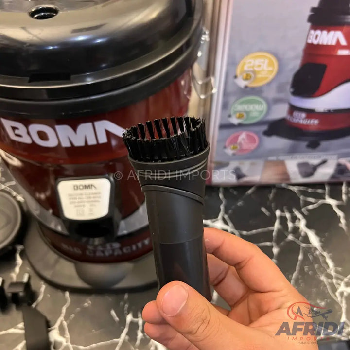 A red and black BOMA vacuum cleaner with a brush attachment.