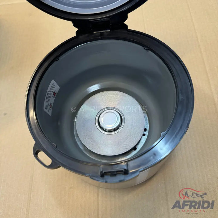 Open rice cooker with a stainless steel heating plate.