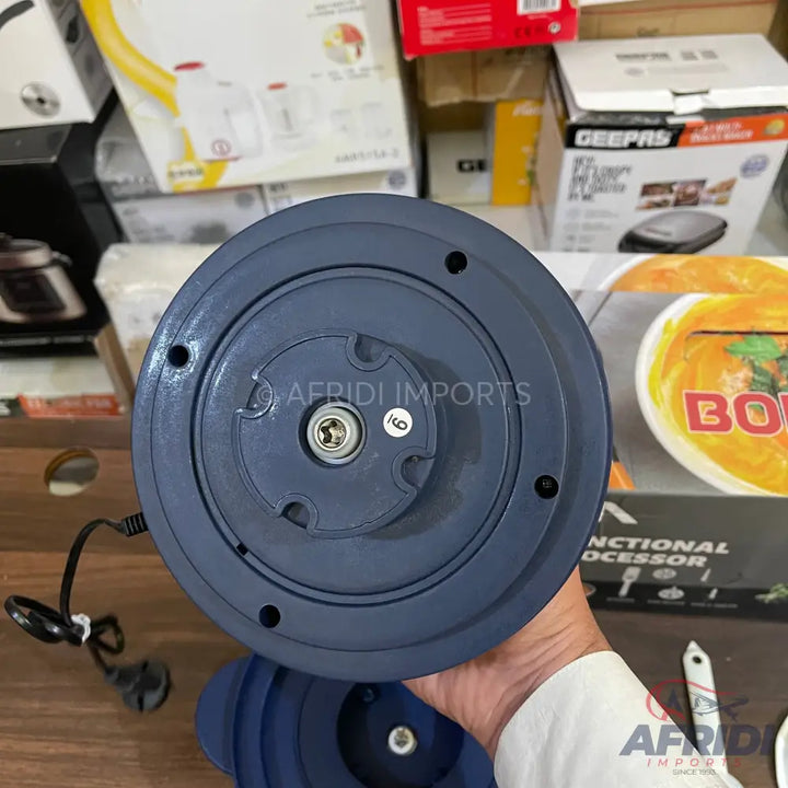 The bottom of a blue blender base with a central rotating mechanism and power cord.