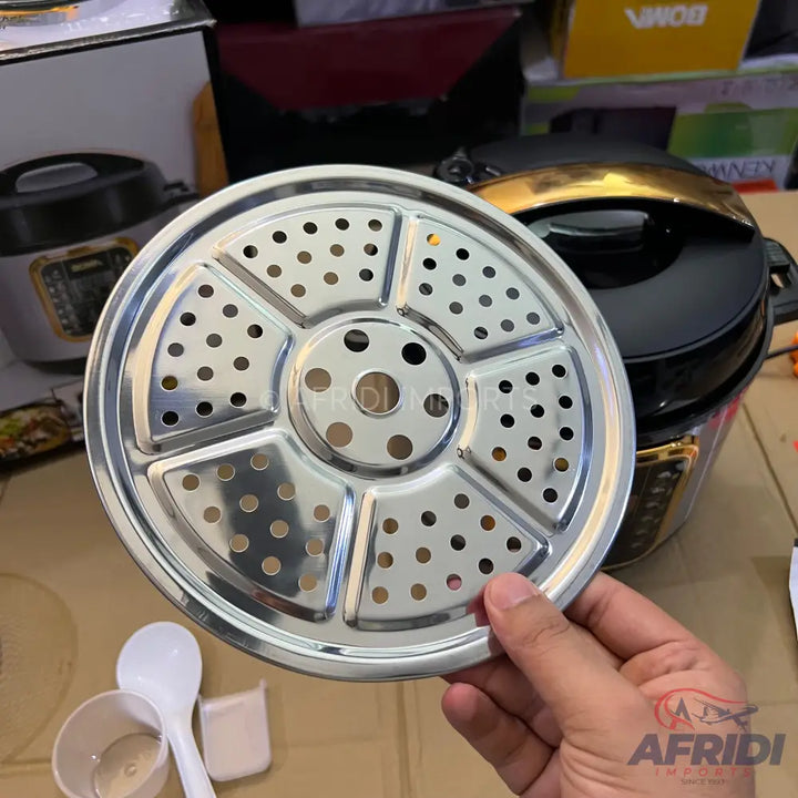 A stainless steel multi-section steamer basket with numerous perforations.