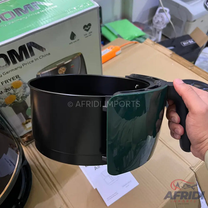 Dark green and black air fryer basket with a handle.