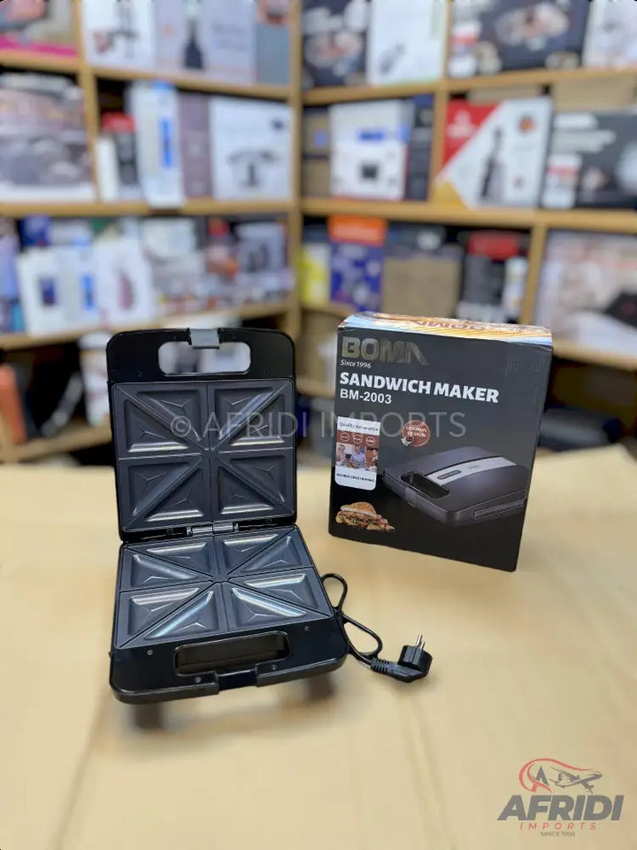 Black sandwich maker with non-stick triangular plates, capable of making four sandwiches at once.