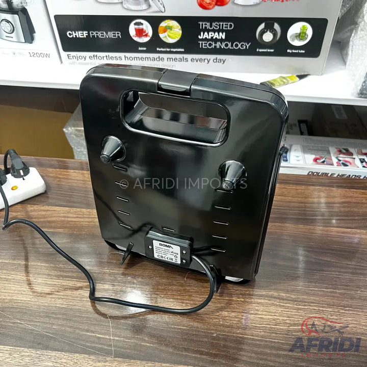 Black electric sandwich maker with a power cord.