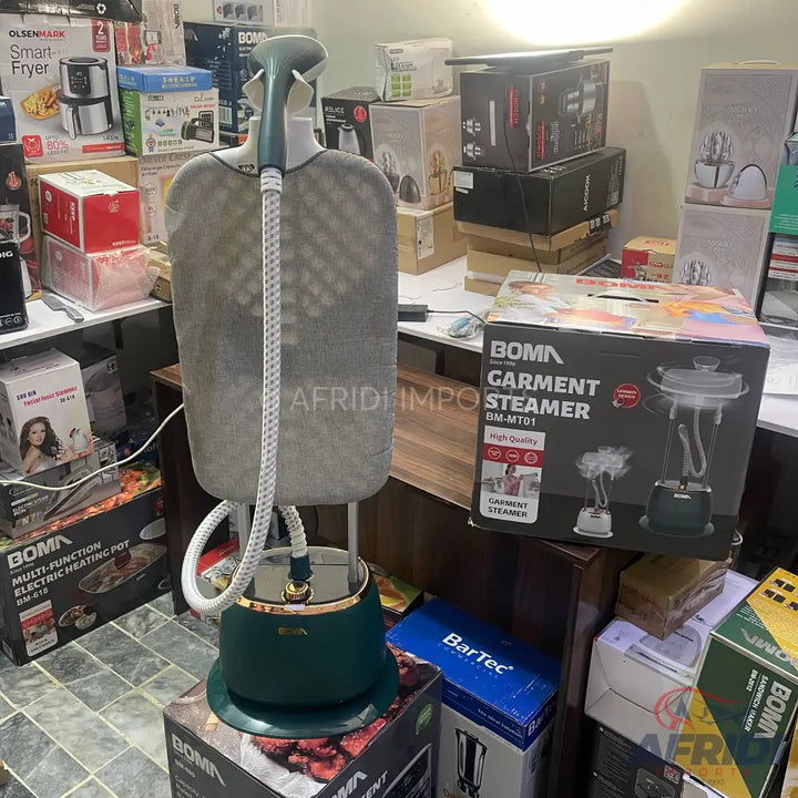 Green and gold standing garment steamer with a fabric-covered hanger.